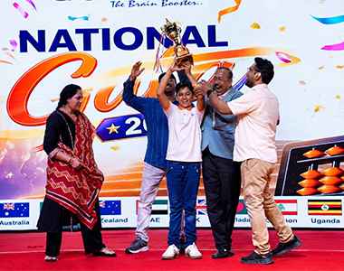A Mastermind Abacus student receiving a trophy at the National competition